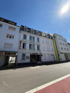 a large white building on the side of a street at City Hotel in Rheinfelden