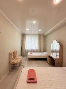 a bedroom with a large bed and a window at Jaily in Astana