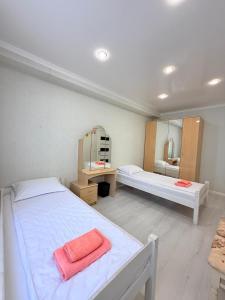 a large room with two beds and a mirror at Jaily in Astana