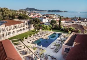 an aerial view of a resort with a pool and chairs at Hotel Palmyra in Argassi