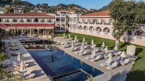 an aerial view of a resort with lounge chairs and a pool at Hotel Palmyra in Argassi