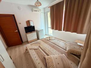 a large wooden bed in a room with a window at Guest House Dayana Double Room 1 in Ravda