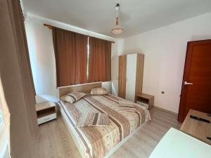 a bedroom with a large bed with pillows on it at Guest House Dayana Double Room 1 in Ravda