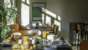 a table with plates of food on top of it at VTF Le Dou De La Ramaz in Montalbert