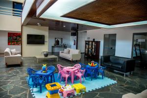 a living room with chairs and tables in a room at Praia Hotel Enseada in Maceió