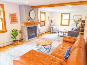 a living room with a couch and a fireplace at Peaceful Winnipesaukee Retreat, Walking Trails in Wolfeboro