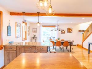 a kitchen and dining room with a table and chairs at Peaceful Winnipesaukee Retreat, Walking Trails in Wolfeboro