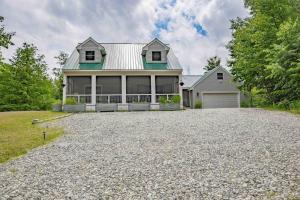 a house with a gravel driveway in front of it at Peaceful Winnipesaukee Retreat, Walking Trails in Wolfeboro