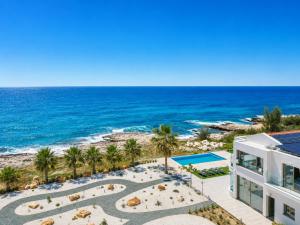 an aerial view of a building and the beach at Villa Stella Sunset in Nea Dimmata