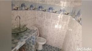 a bathroom with a sink and a toilet at Perles de ngaparou in Saly Portudal