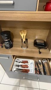 a drawer in a cabinet filled with utensils at Sobrado Tropical a 1 Km da faculdade Unic e UFMT in Cuiabá
