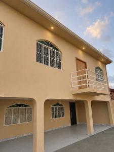 a house with a balcony on the side of it at Sobrado Tropical a 1 Km da faculdade Unic e UFMT in Cuiabá
