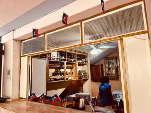 a bar with a person standing in front of a bar at BAYO-HOTEl in Cap-Haïtien