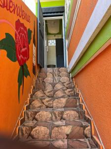 a staircase with a flower painted on the side of a building at BAYO-HOTEl in Cap-Haïtien +2 photos