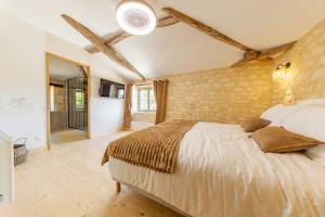 a bedroom with a large bed in a room at La Châtellerie du Gagnon in Champagnolles +31 photos