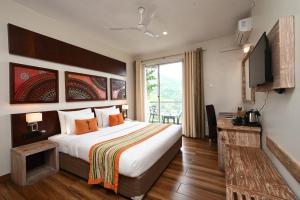a hotel room with a bed and a television at Skyloft Kandy in Kandy