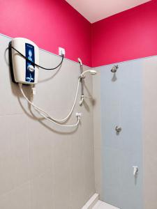 a shower in a bathroom with a pink wall at Sigiri Lion Lodge in Sigiriya +36 photos