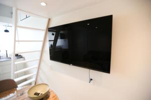 a flat screen tv hanging on a wall at Exclusive 1 bedroom apartment in Copenhagen