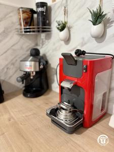 a red coffee maker sitting on top of a counter at L'oustal de sandy in Cascastel-des-Corbières
