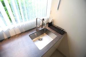 a kitchen sink in a counter with a window at Exclusive 1 bedroom apartment in Copenhagen +11 photos