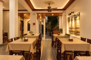 a restaurant with tables and chairs in a room at TamCoc Golden Mountain Homestay in Vũ Lâm