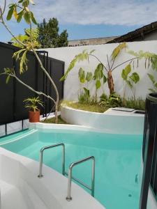 a blue swimming pool in a backyard with plants at Shira Villa in Seturan