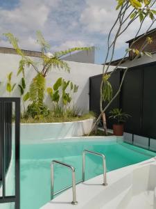 a swimming pool with a table and a swimming pool at Shira Villa in Seturan