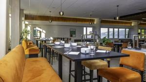 a restaurant with tables and chairs in a room at VTF Le Dou De La Ramaz in Montalbert +18 photos