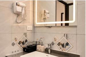 a bathroom with a sink and a mirror at TamCoc Golden Mountain Homestay in Vũ Lâm +54 photos
