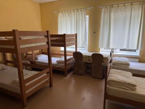 a room with three bunk beds and a window at Guest House KARTA F M in Kamianets-Podilskyi