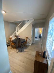 a living room with a table and chairs and a staircase at The Heart house in Indianapolis +13 photos