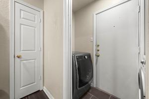a television sitting in a room next to a door at Urban Loft in Killeen +22 photos