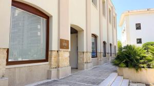 a building with a window on the side of a street at LA PIETRA Residence in Trani