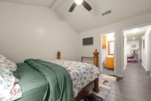a bedroom with a bed with a green comforter at Urban Loft in Killeen