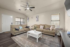 a living room with two couches and a table at Urban Loft in Killeen