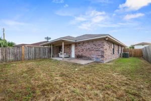 a brick house with a fence in a yard at Urban Loft in Killeen