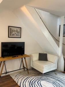 a living room with a tv and a couch and a table at Stay at 48 in Oulton
