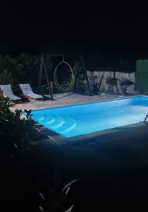 a large blue swimming pool at night at Vila Stancevic wellness in Sremski Karlovci