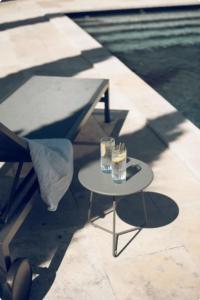a table with drinks on it next to a pool at La Villa Saint-Antoine in Violès +15 photos