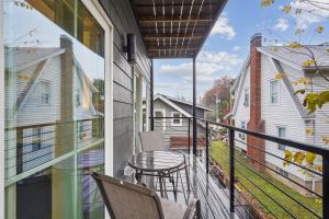 a balcony with a table and chairs on it at Mary's Stay Brookland in Washington, D.C.