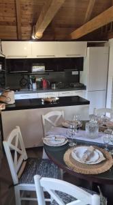 a kitchen with a table with plates and glasses on it at Vila Stancevic wellness in Sremski Karlovci