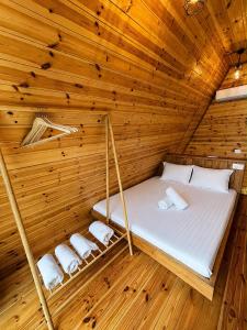 a room with a bed in a wooden cabin at Rozafa Sunset in Shkodër