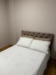 a bedroom with a bed with two pillows on it at Apartman Laki in Bijeljina