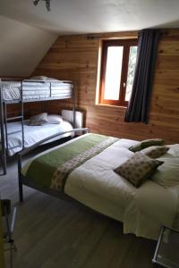 a bedroom with two bunk beds and a window at Hôtel Restaurant Ardesia in Peyrelevade
