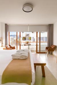 a bedroom with a bed and a living room at Baños del Inca Premium Hotel in Los Baños del Inca