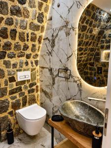 a bathroom with a sink and a toilet and a tub at Rozafa Sunset in Shkodër +27 photos