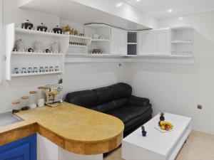 a living room with a black leather couch and a table at Atlas - Appartement moderne in Fez +17 photos