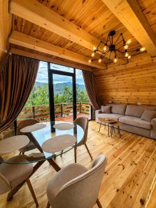 a living room with a glass table and chairs at Rozafa Sunset in Shkodër