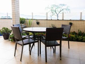 a table and chairs sitting on a patio at Ville de Montagne Hotel in Brumadinho