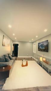 a living room with a couch and a table at Hamilton Central 3BR Family House in Hamilton